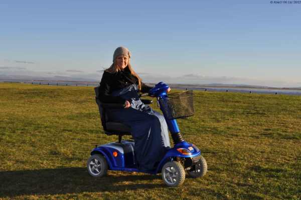 Comfortable mobility scooter for outdoor use in scenic countryside locations.