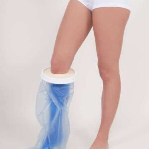 Light beige prosthetic leg with a socket joint, standing next to a disabled toilet with bidet and handrails.