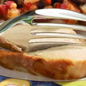 Delicious roasted chicken breast with crispy skin served on a colourful plate.
