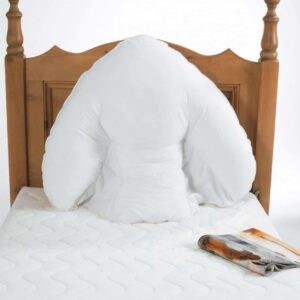 Comfortable white pillow on wooden bed headboard, ideal for mobility and daily living aid.