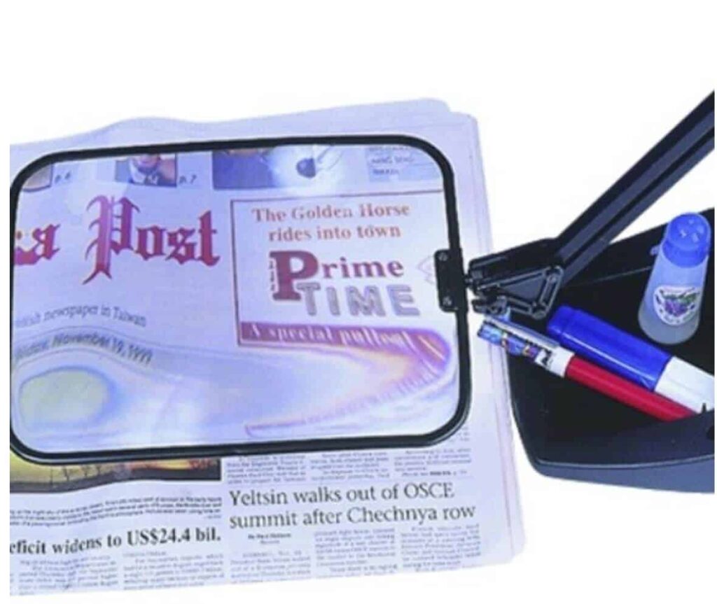 Bright digital magnifier for reading newspapers, ideal for mobility and visual aids.