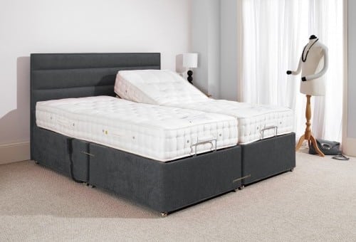 Comfortable adjustable bed with firm mattress for better mobility and sleep support.