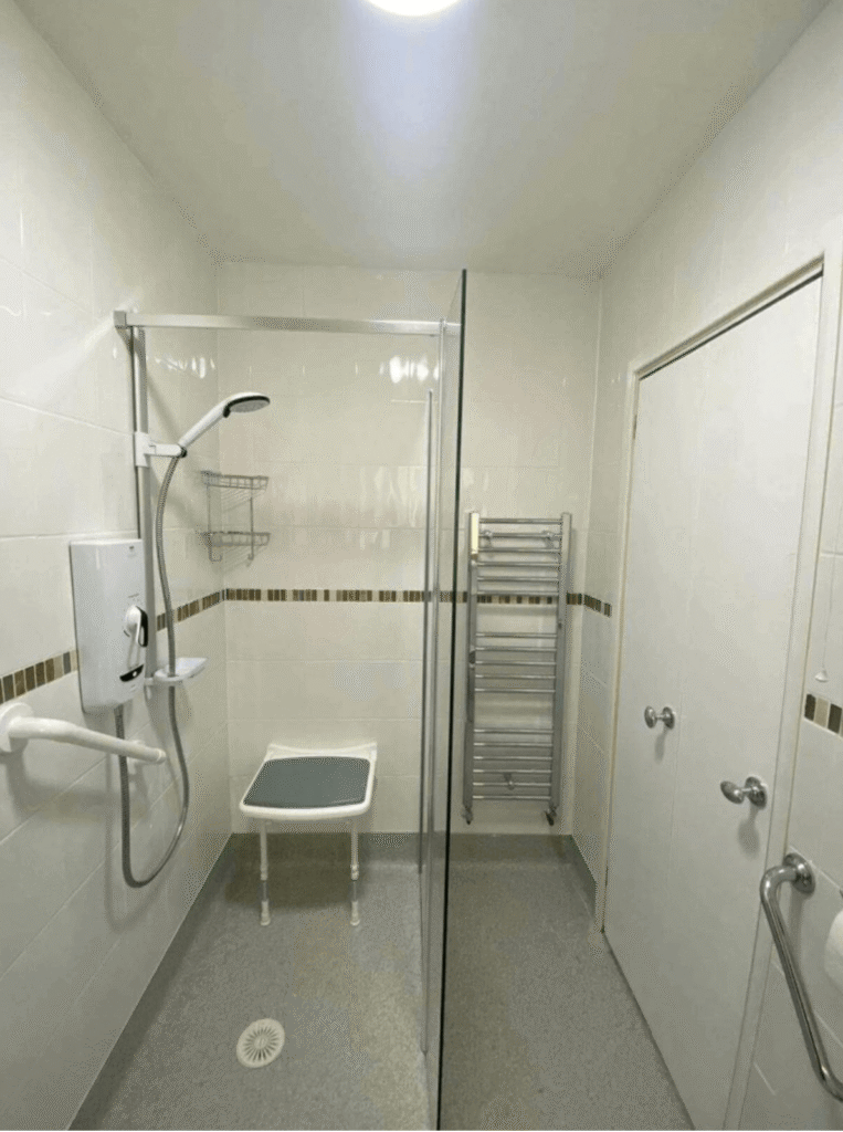 Accessible Shower Room with Disabled Features and Mobility Support Equipment.